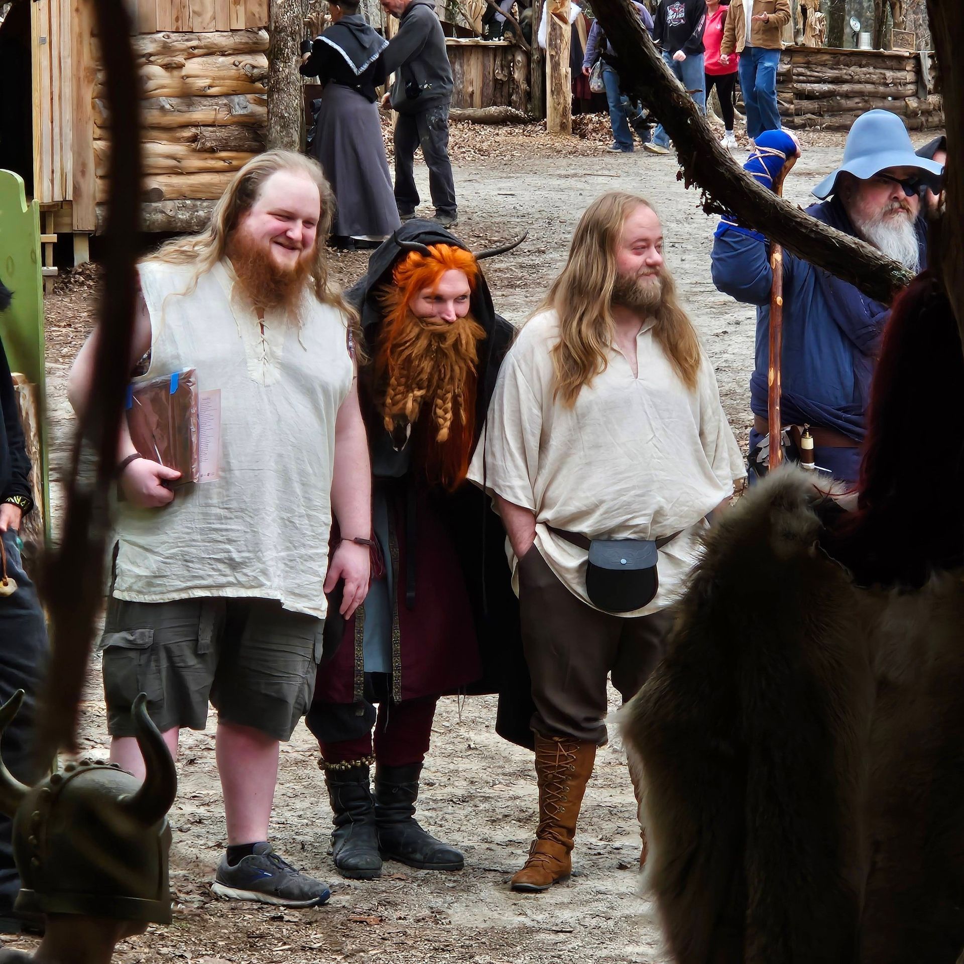 three kids dressed up talking to a man dressed up as a pirate.