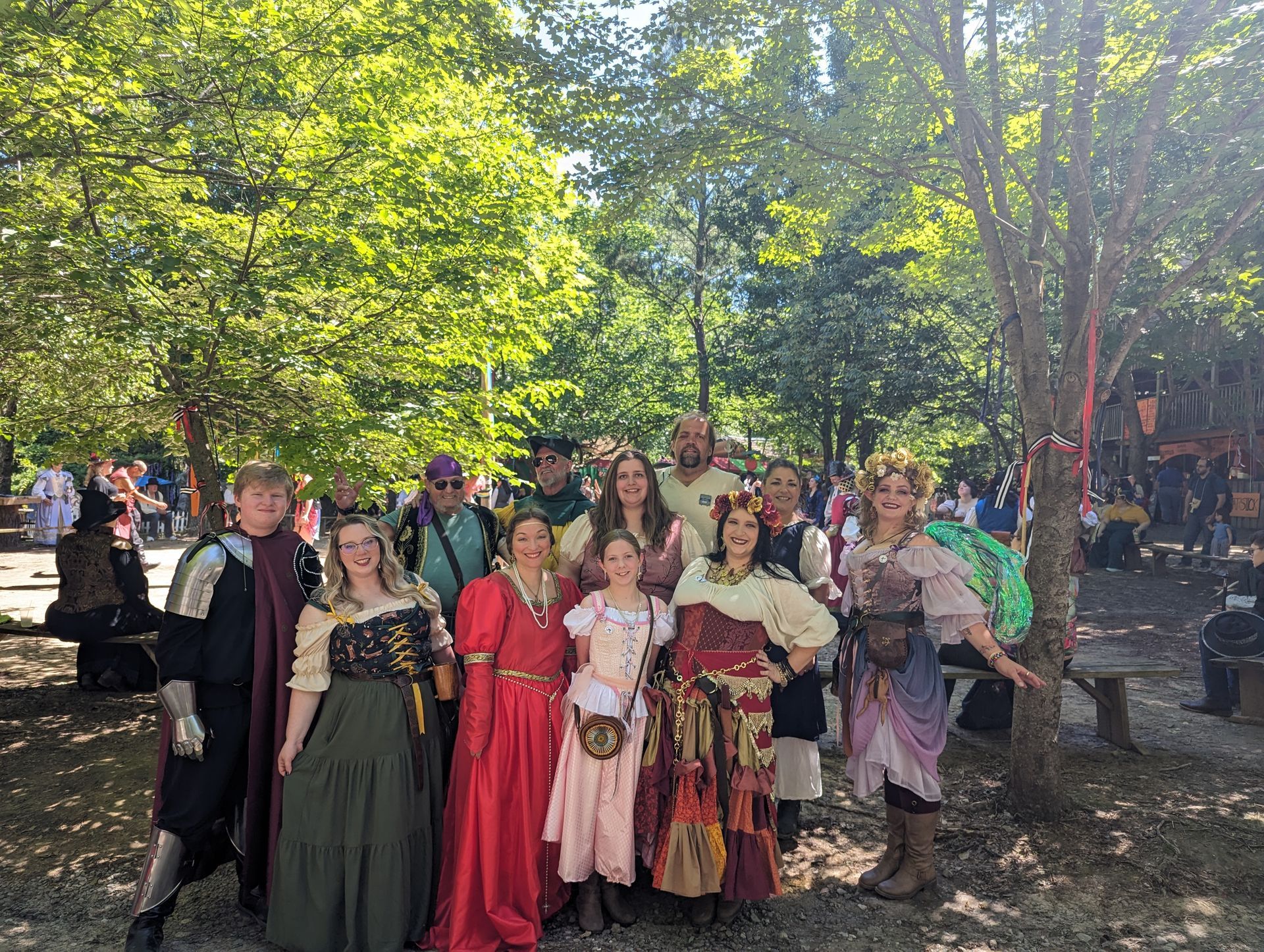 A group of people dressed in medieval costumes are posing for a picture.