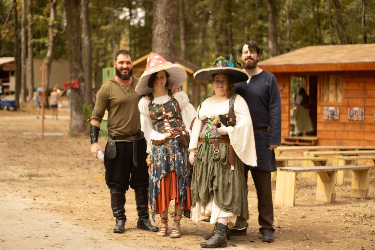 A group of people dressed in medieval costumes are posing for a picture.