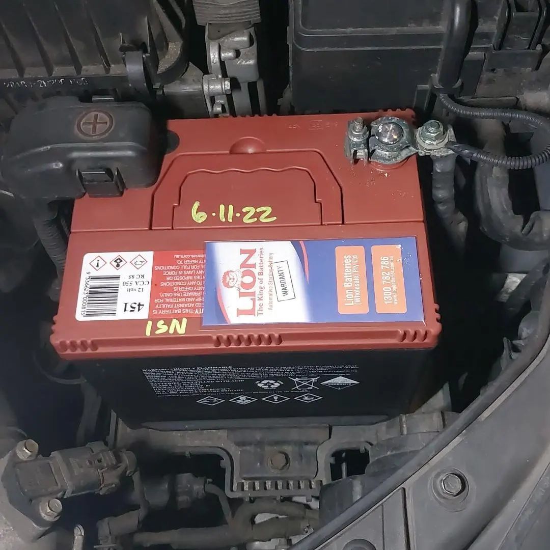 A Lion Battery Is Under The Hood Of A Car — Battery Assist QLD In Brendale, QLD