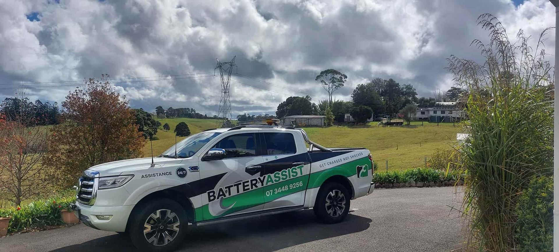 A White And Green Truck Is Parked On The Side Of The Road — Battery Assist QLD In Bracken Ridge, QLD