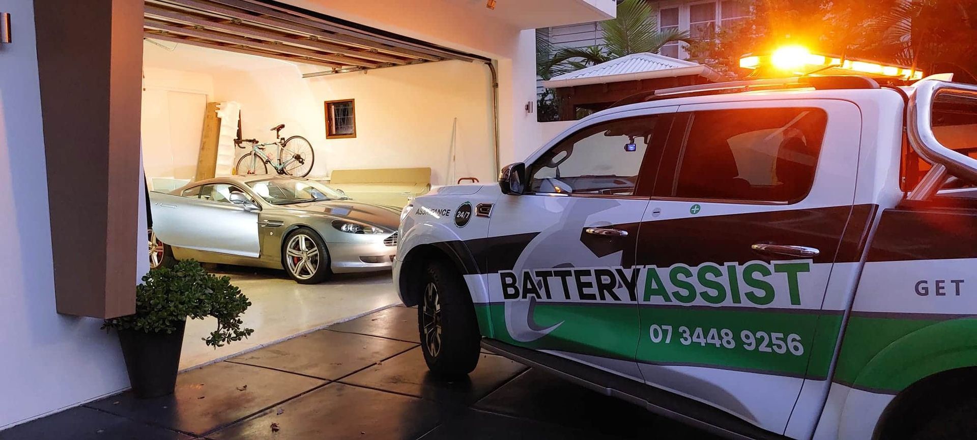 A Car Is Parked In A Garage Next To A Battery Assist Truck — Battery Assist QLD In Bracken Ridge, QLD