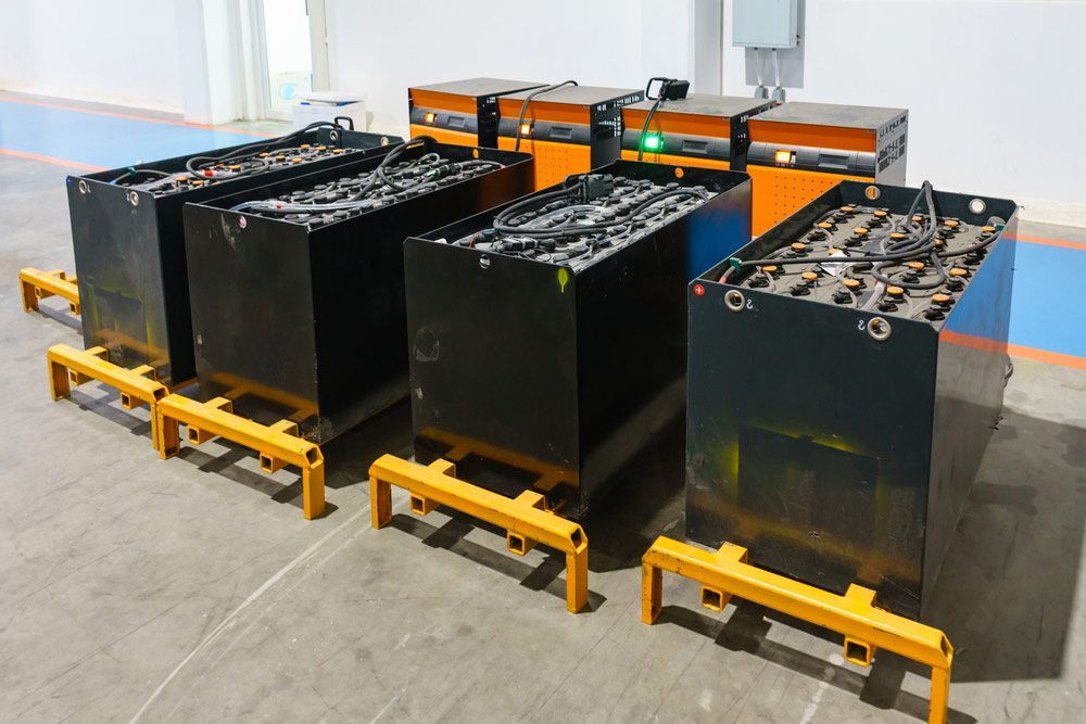 A Row of Batteries Are Sitting on a Concrete Floor — Battery Assist QLD In Brendale, QLD