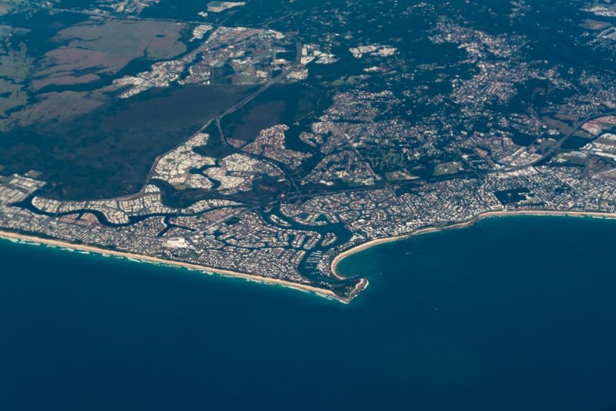 An Aerial View of a Residential Area With a Blue Sky and Clouds — Battery Assist QLD In Kawana Waters, QLD
