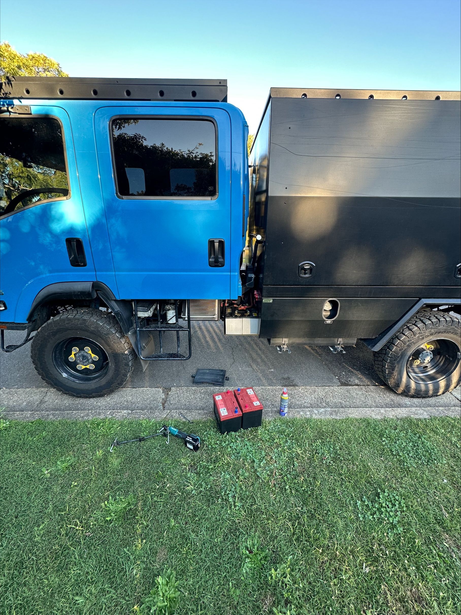 A Close Up Of A Car Battery With A Charger Attached To It — Battery Assist QLD In Bracken Ridge, QLD