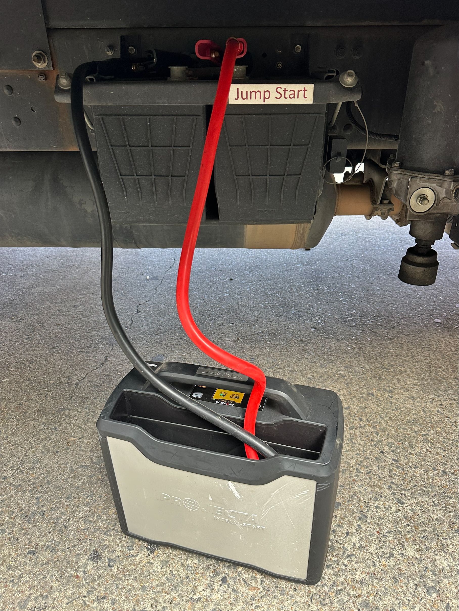 A Man Is Working On An Engine With A Truck — Battery Assist QLD In Bracken Ridge, QLD