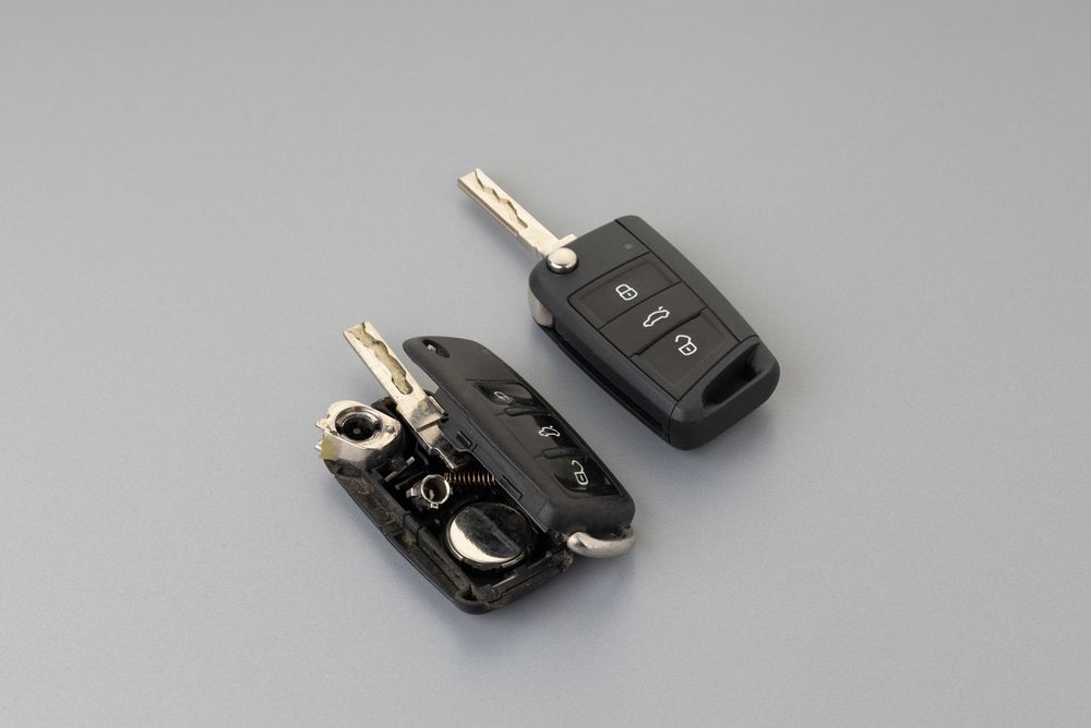 Front Two Car Keys Are Sitting On A Gray Surface — Battery Assist QLD In Bracken Ridge, QLD