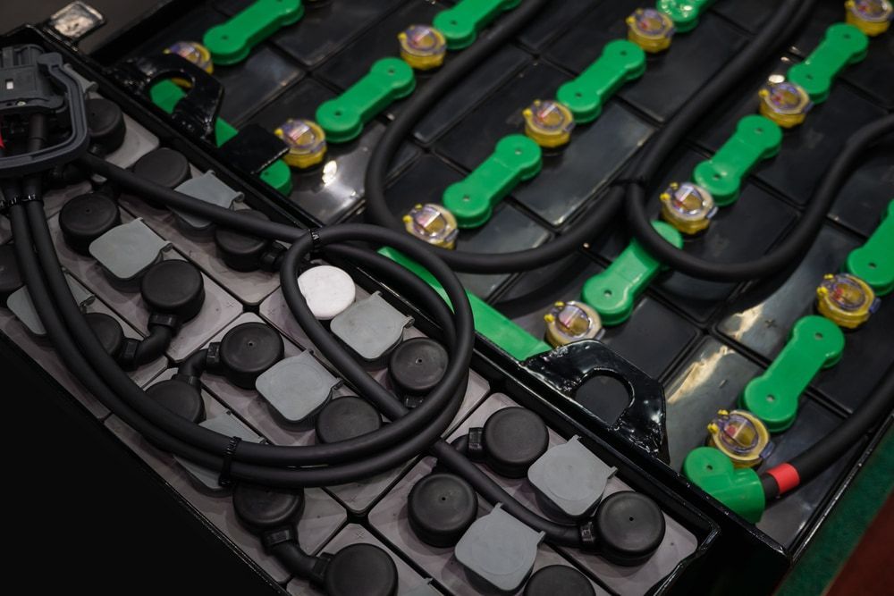 A Bunch Of Batteries Are Sitting On Top Of Each Other On A Table— Battery Assist QLD In Bracken Ridge, QLD