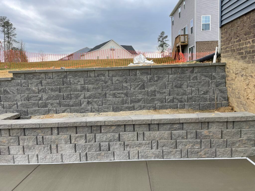 A brick wall is being built in front of a house.