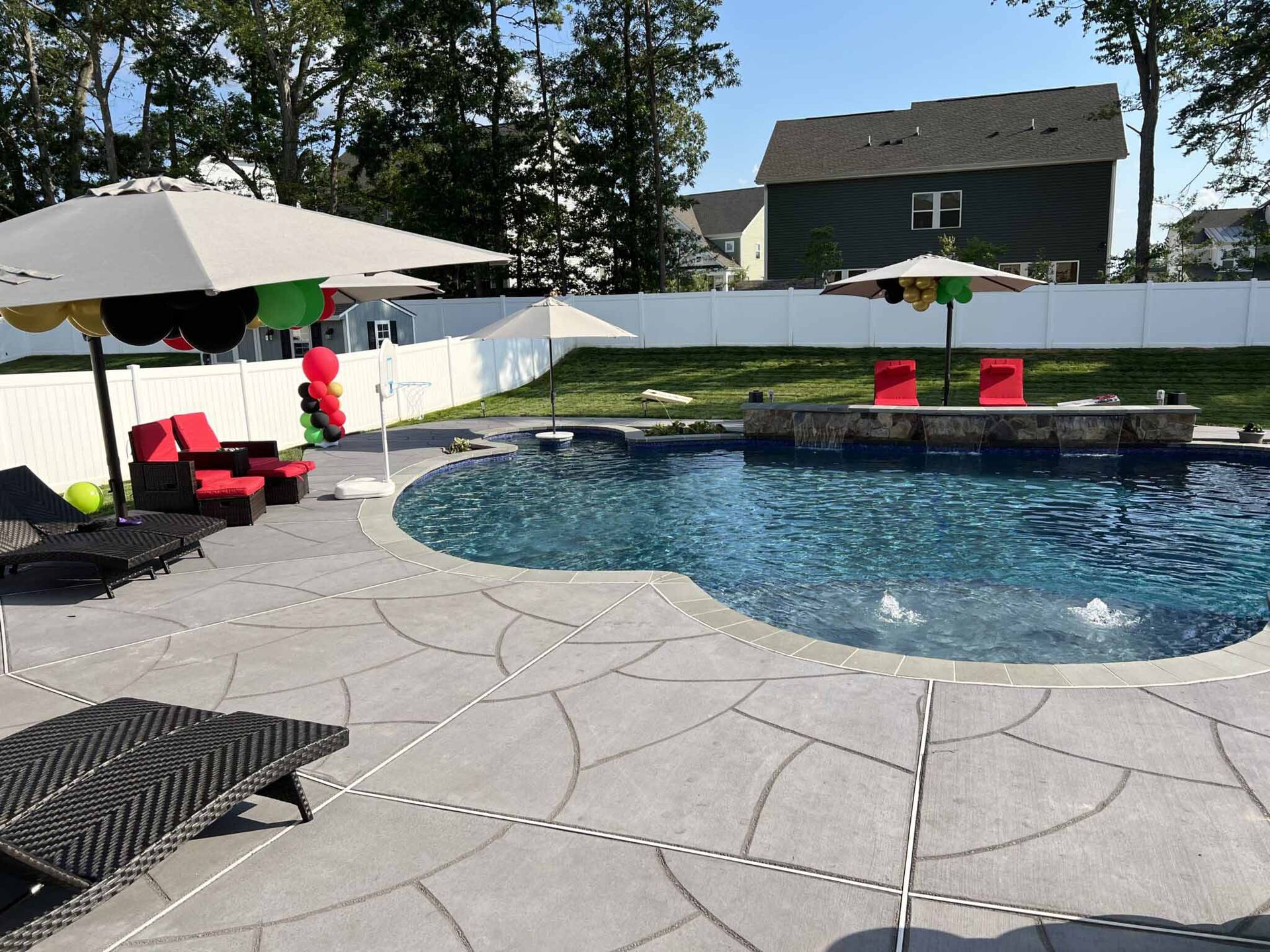 A large swimming pool with umbrellas and chairs around it