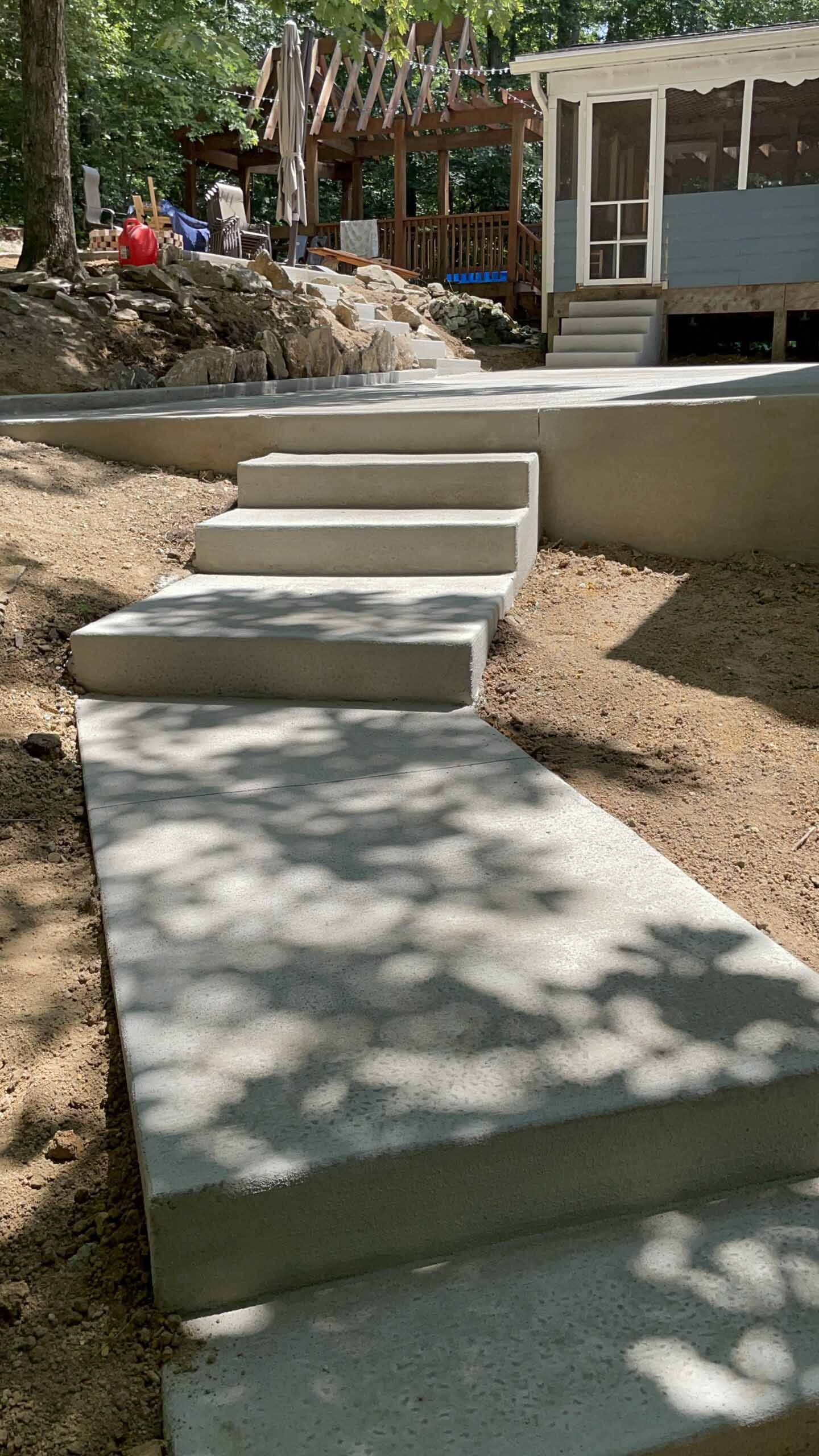 A set of concrete stairs leading up to a house.