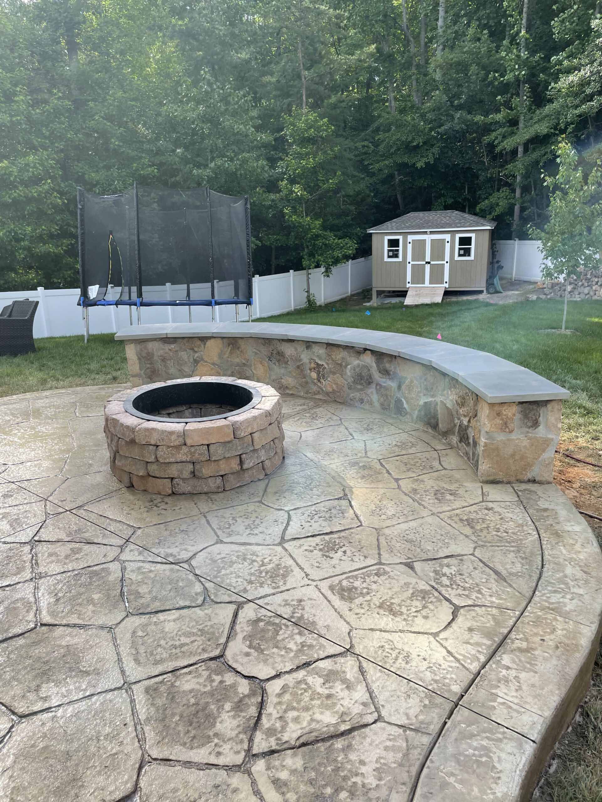 There is a fire pit in the middle of the patio.