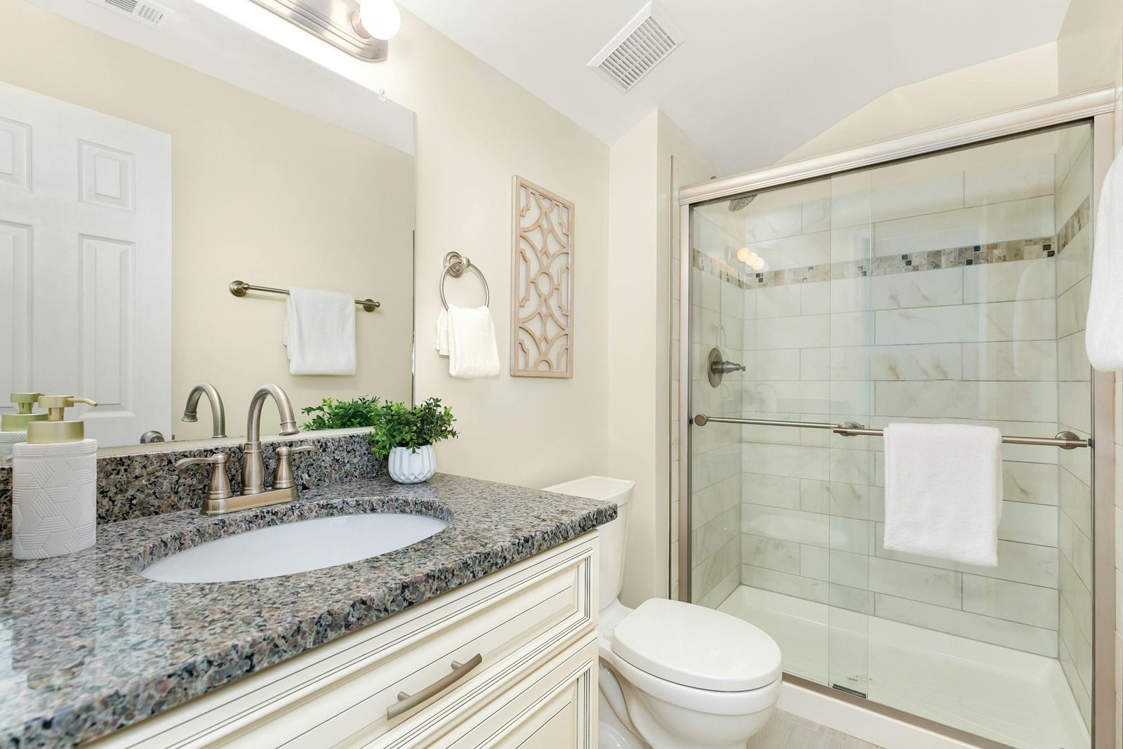 A bathroom with a sink , toilet and shower.