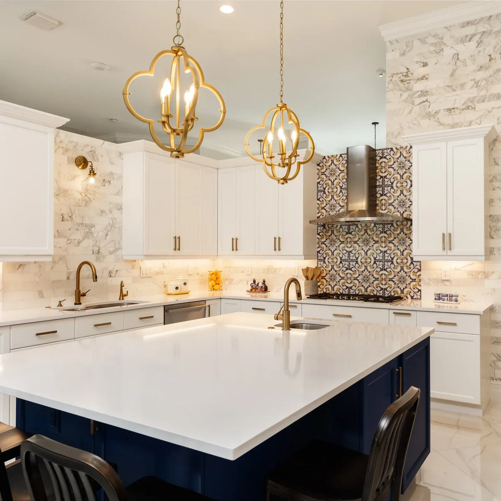 A kitchen with white cabinets and a blue island