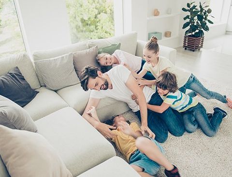 Heating & Cooling — Family having fun on the couch in Mineral Ridge, OH