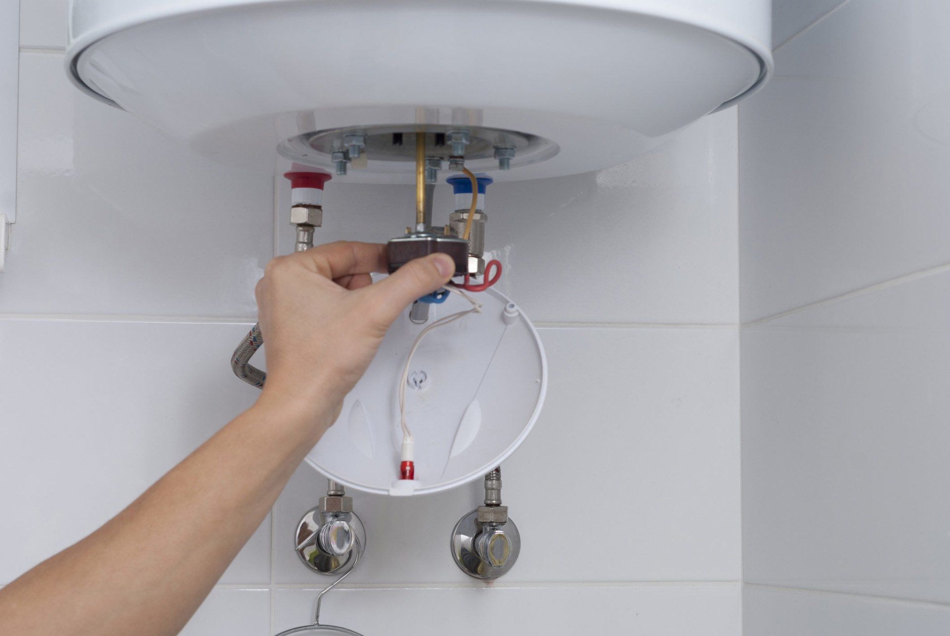 Water Heaters — Man Repairing the Boiler in Louisville, KY