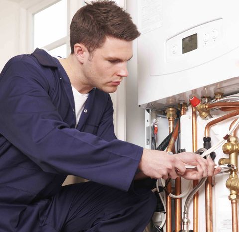 Commercial Boilers — Man Fixing the Boiler in Louisville, KY
