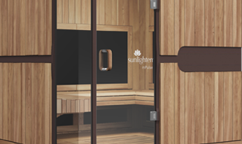 A wooden sauna with a glass door and a black wall.