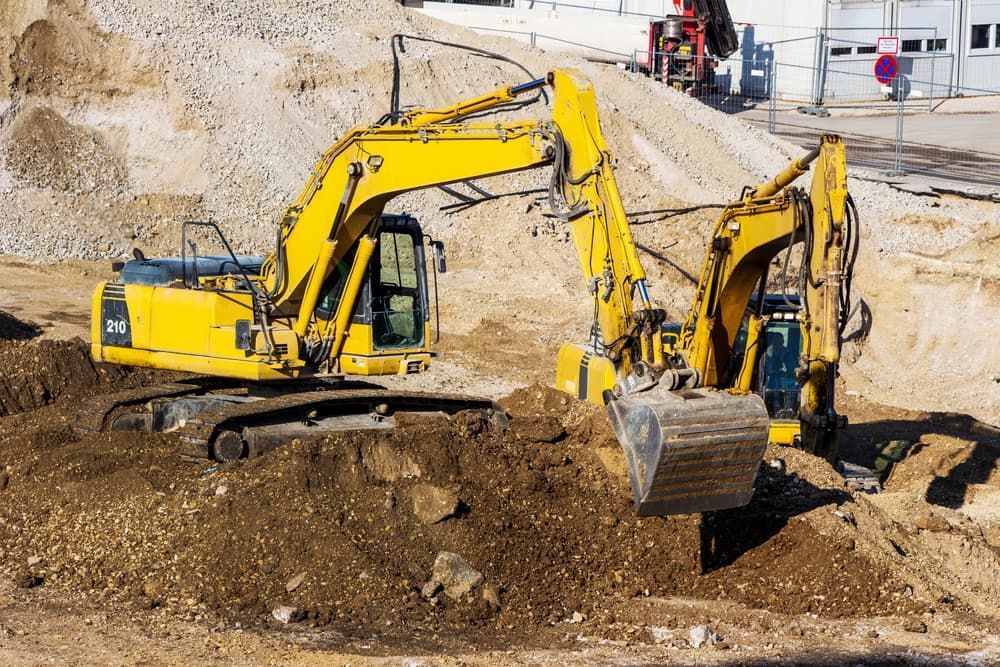 Two Yellow Excavators Are Working on a Construction Site — Dino's Bobcat–Bitumen & Excavator Hire in Cushnie, QLD