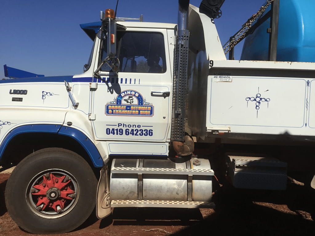 A White and Blue Truck With a Phone Number on the Side — Dino's Bobcat–Bitumen & Excavator Hire in Cushnie, QLD