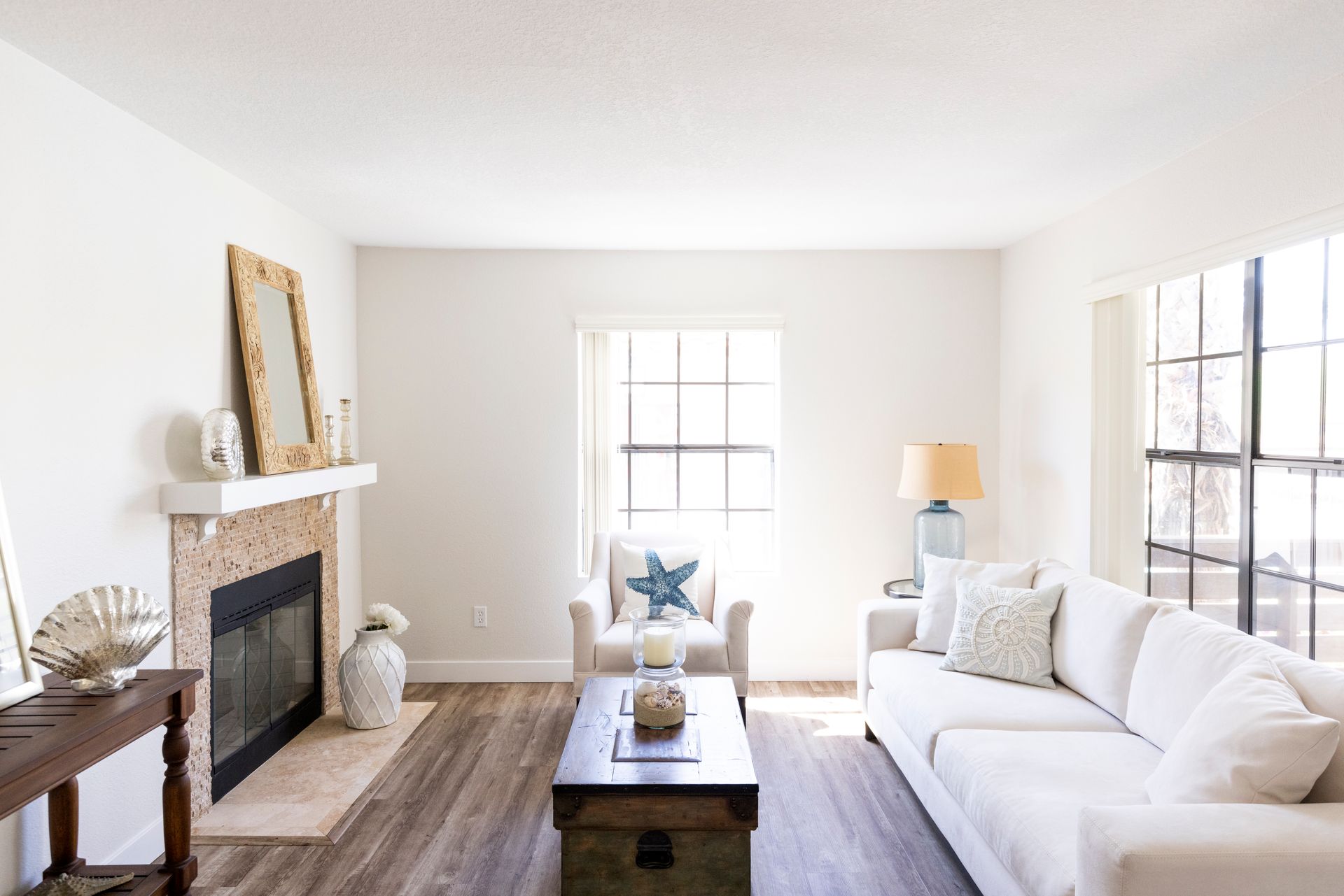 Living Room with a white couch and plenty of natural lighting alternate angle