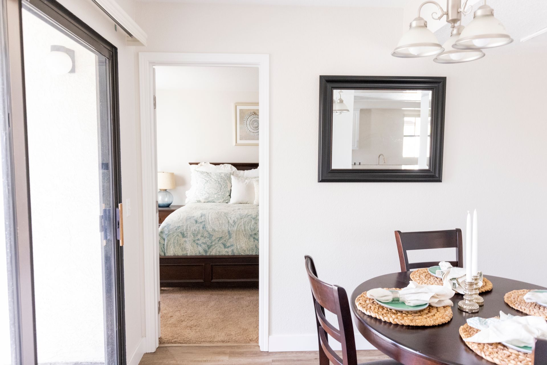 Dining area photo with bedroom in background