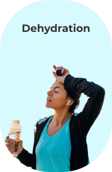 A woman is sweating while holding a bottle of water.