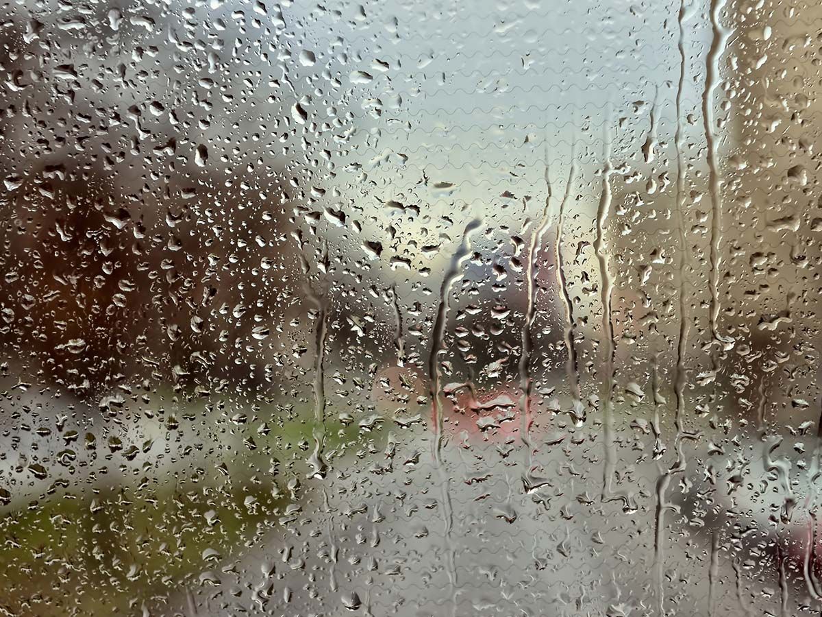 A close up of a window with rain drops on it