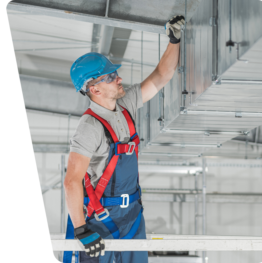 A man is working on a ceiling in a building.