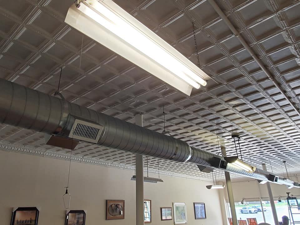 A ceiling with a lot of pipes hanging from it