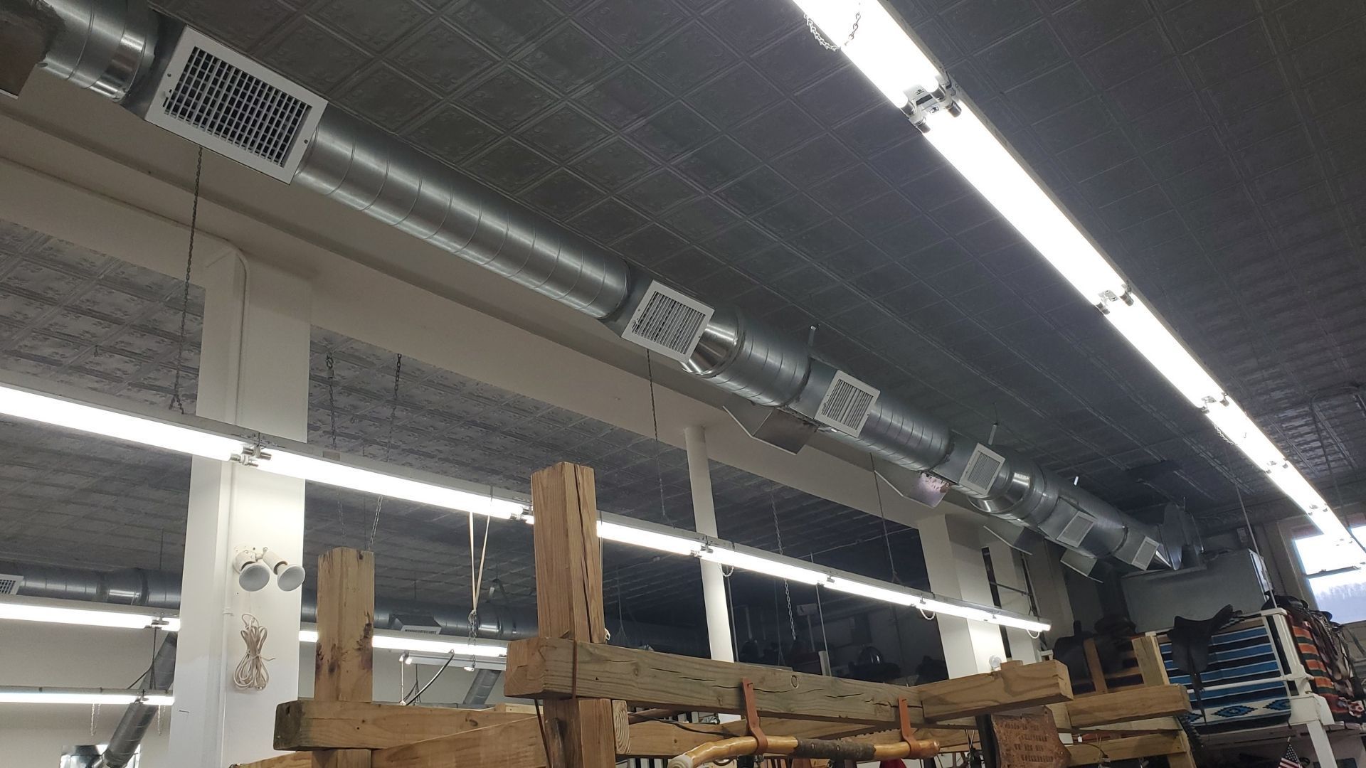 A warehouse with a lot of wooden pallets hanging from the ceiling.