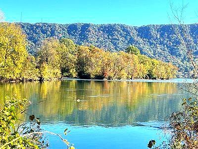 A lake surrounded by trees on a sunny day with mountains in the background in Colonial Heights Tennessee