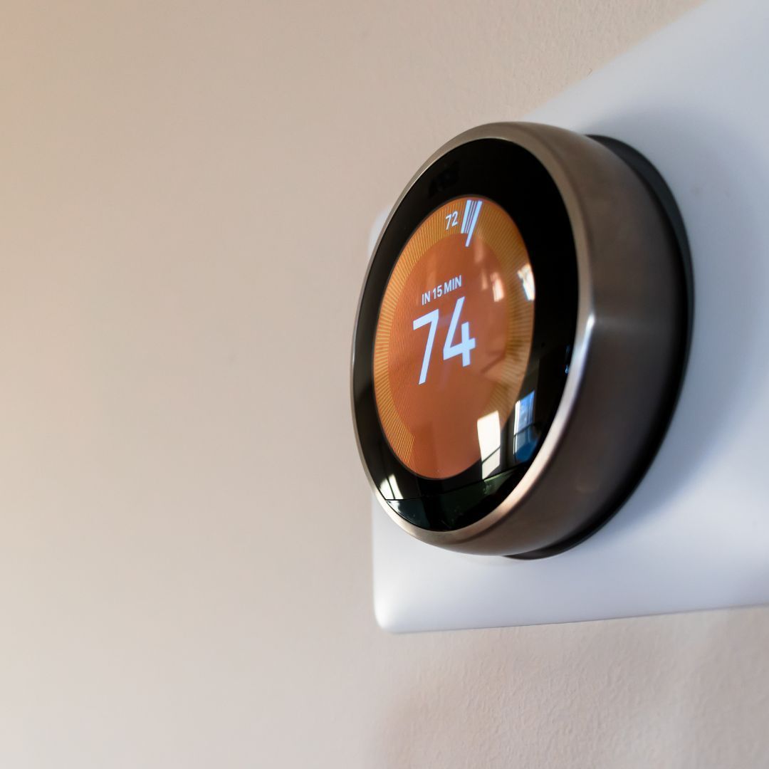 A round thermostat with the number 74 on it