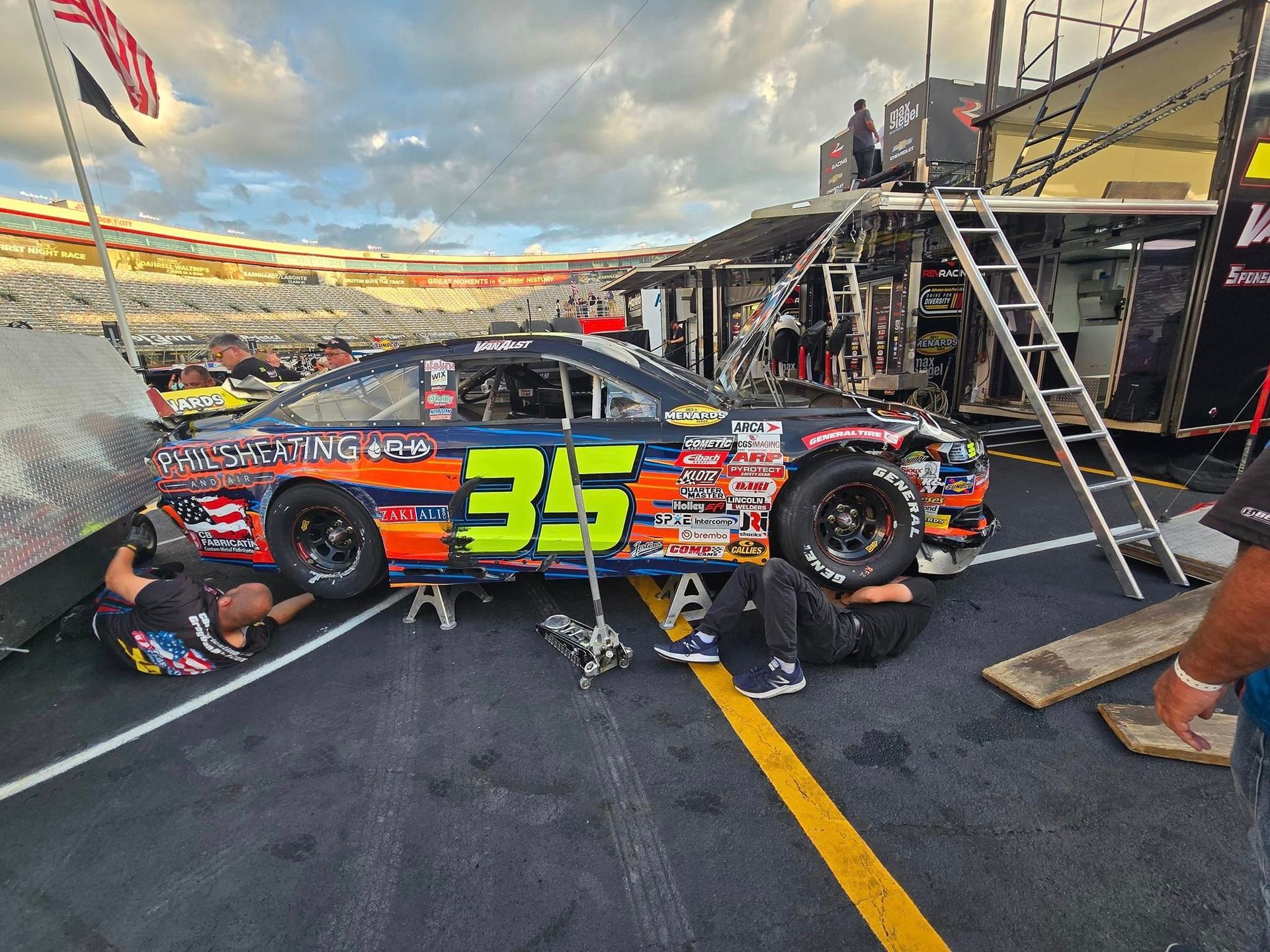 A race car with the number 35 on it is parked in a parking lot.