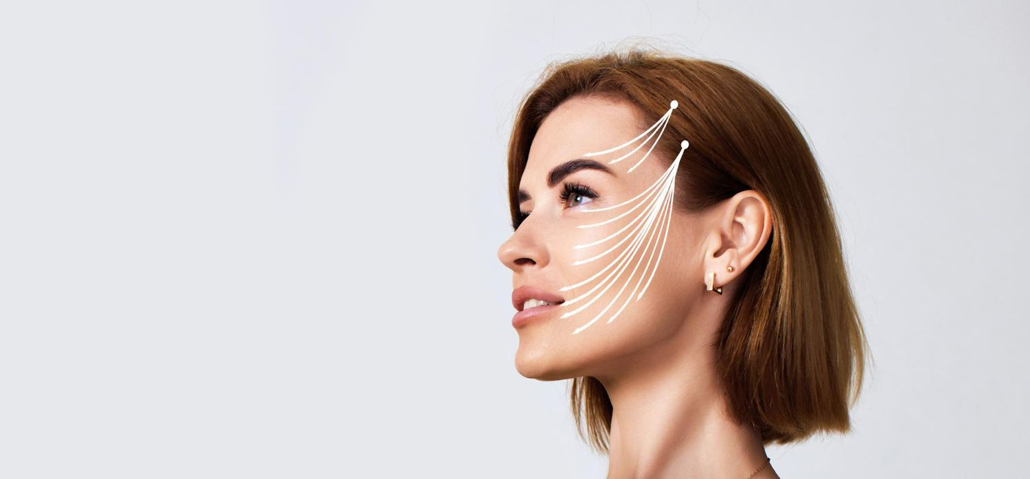 A close up of a woman 's face with lines drawn on it.