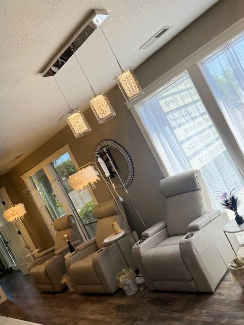 A living room with a lot of chairs and lamps