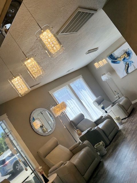 A living room with a lot of chairs and lamps