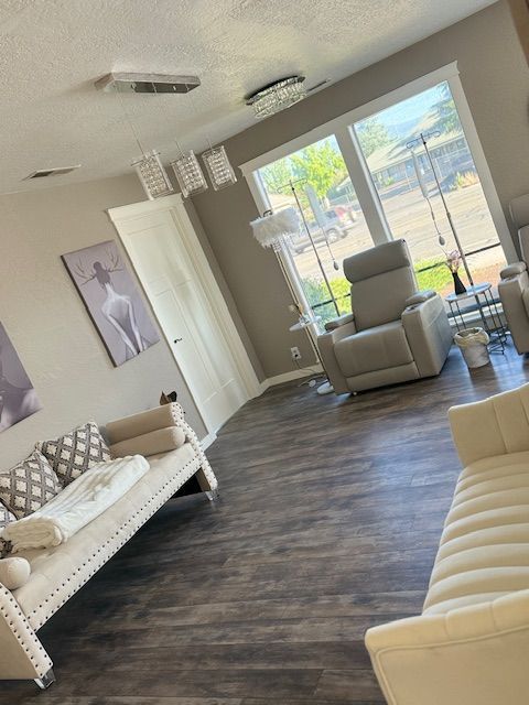 A living room with a couch and two chairs