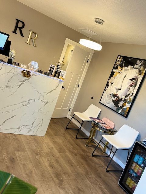 A waiting room with a marble counter and chairs