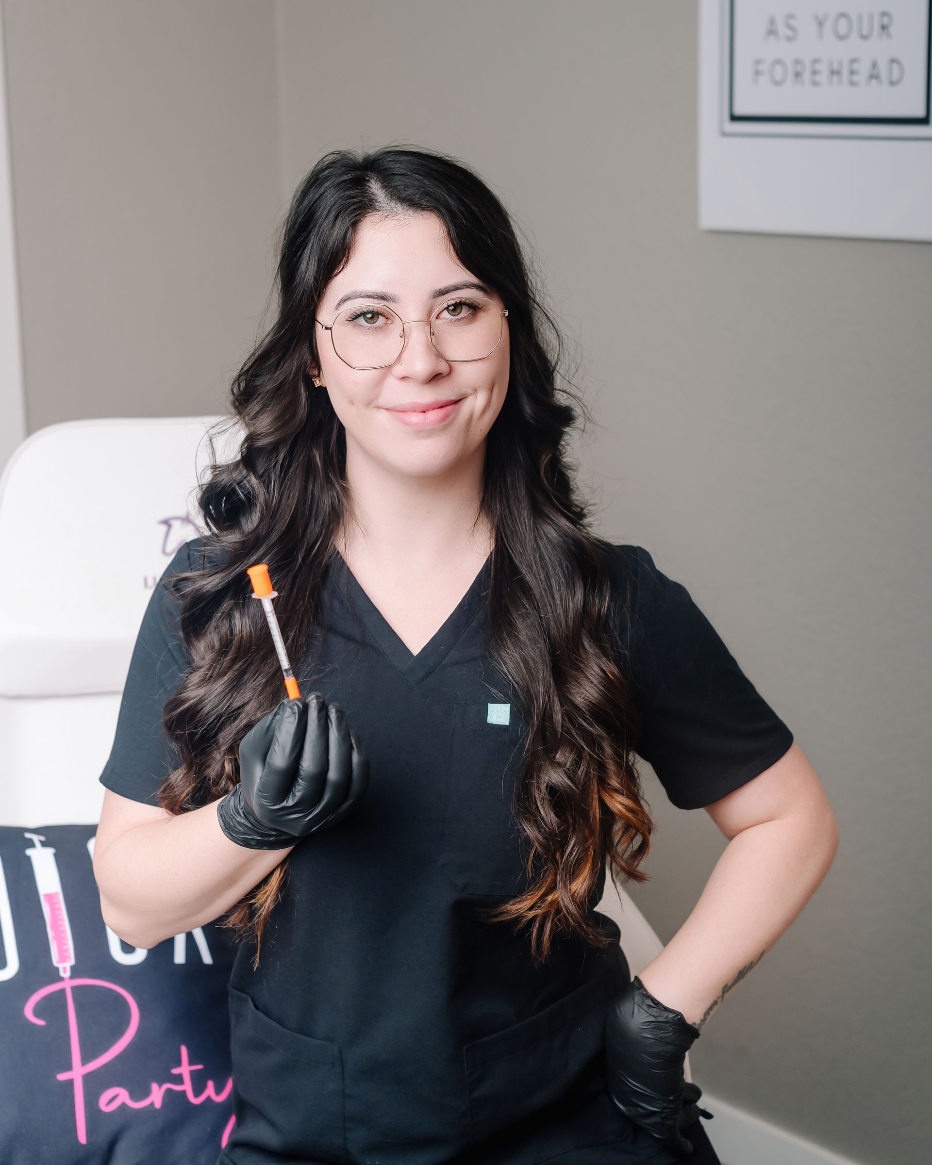 A woman is holding a stethoscope around her neck and smiling.