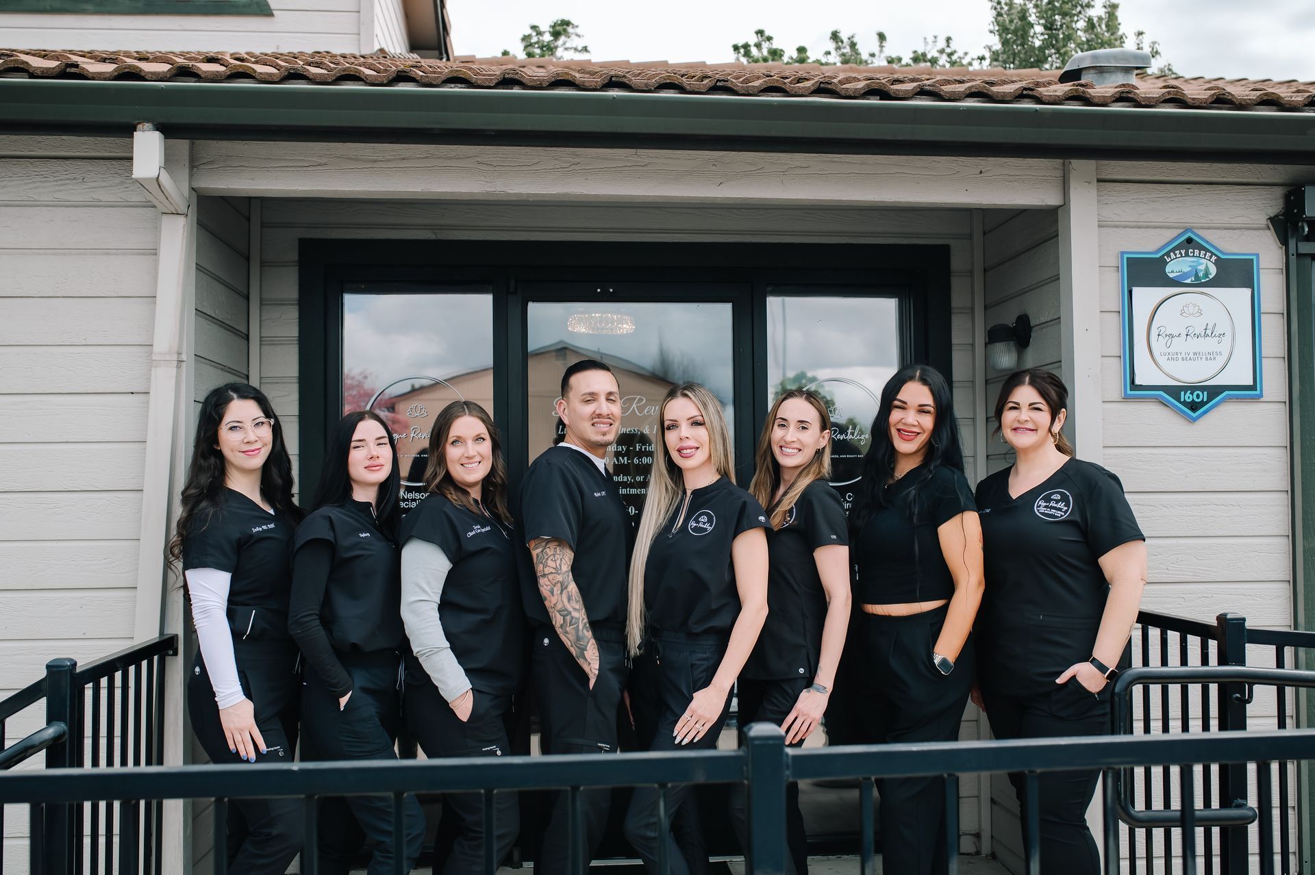 A group of people are posing for a picture in front of a building.