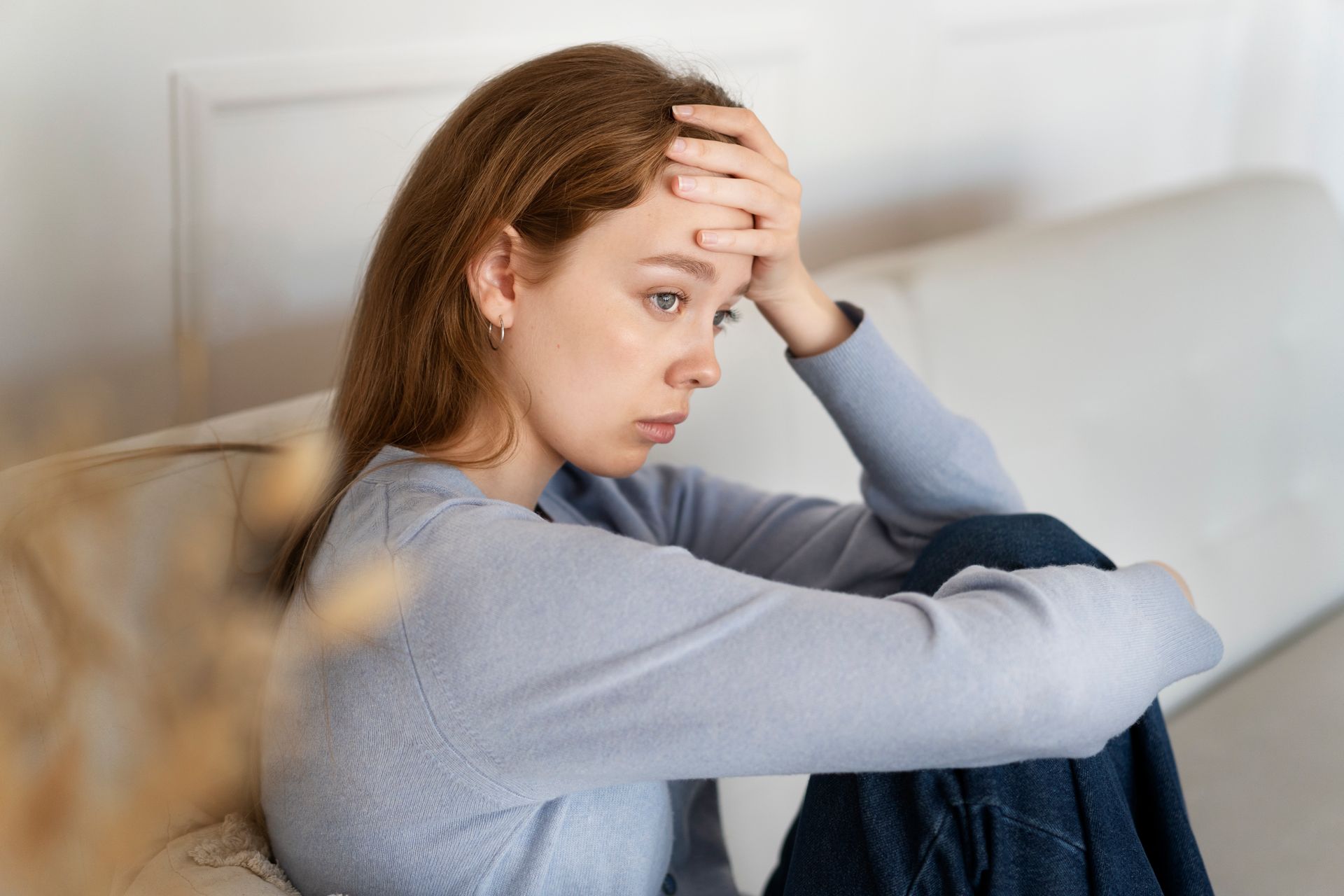 a woman is sitting in a chair holding a cell phone .