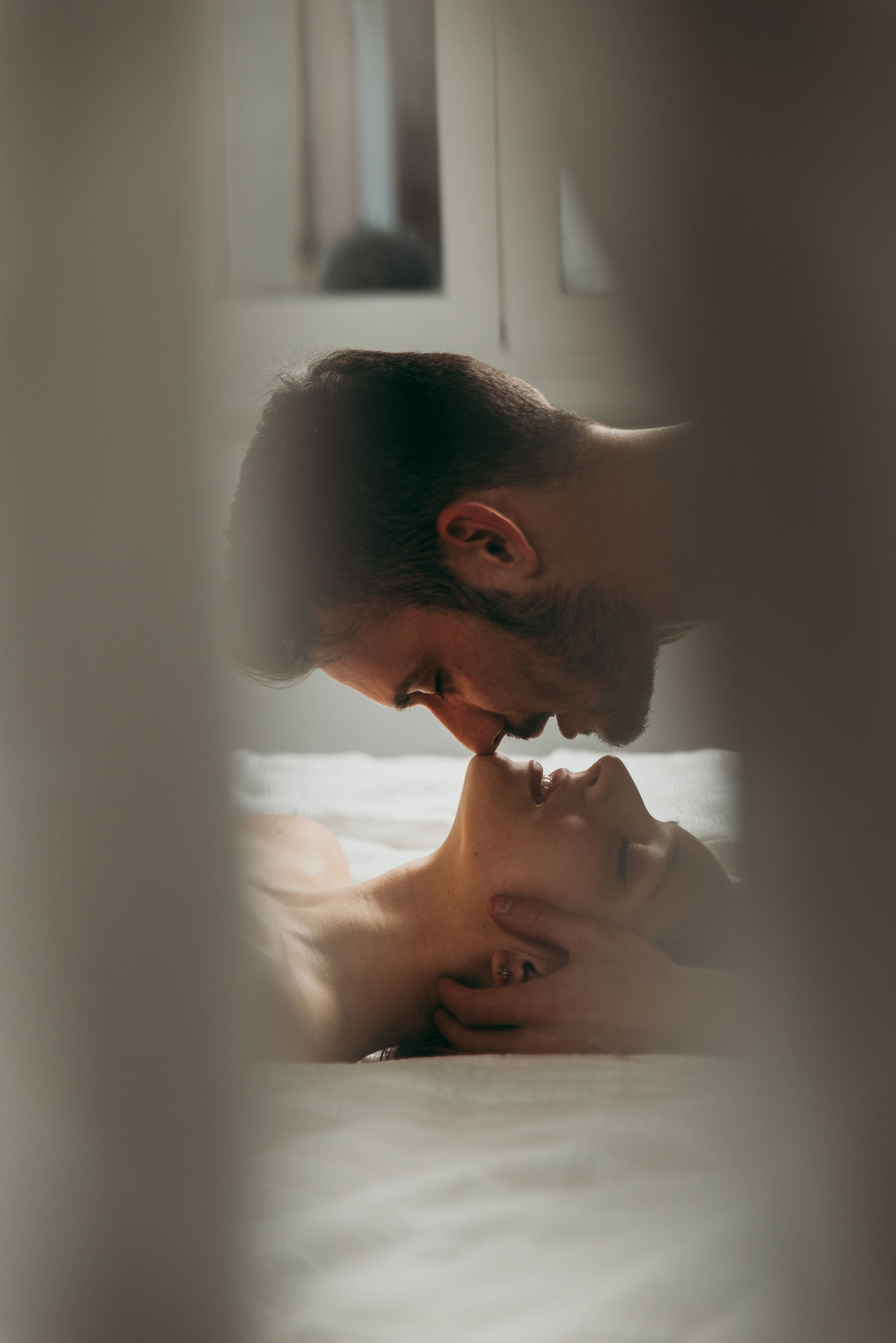 A woman and a man are about to kiss