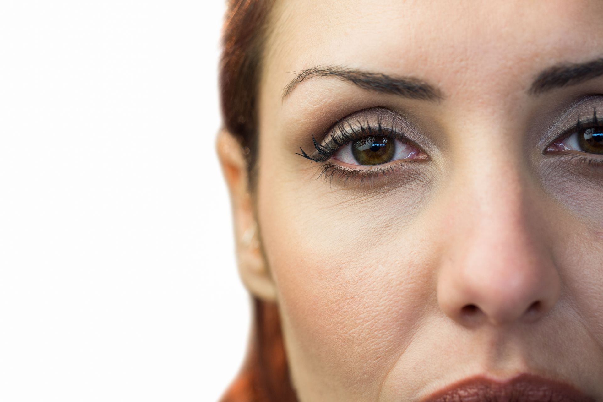 A close up of a woman 's face on a white background.