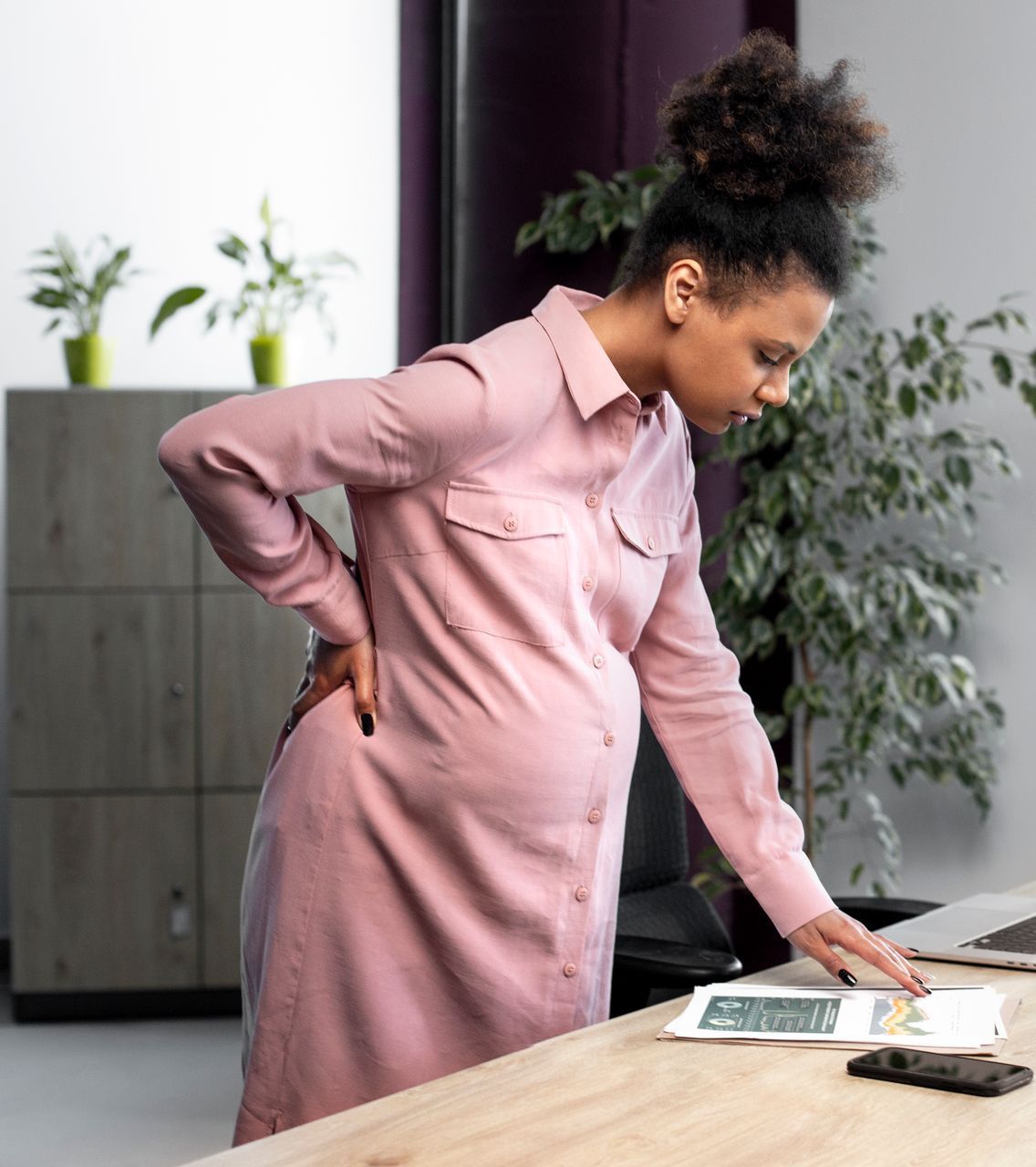 A woman with her eyes closed is holding her head in pain