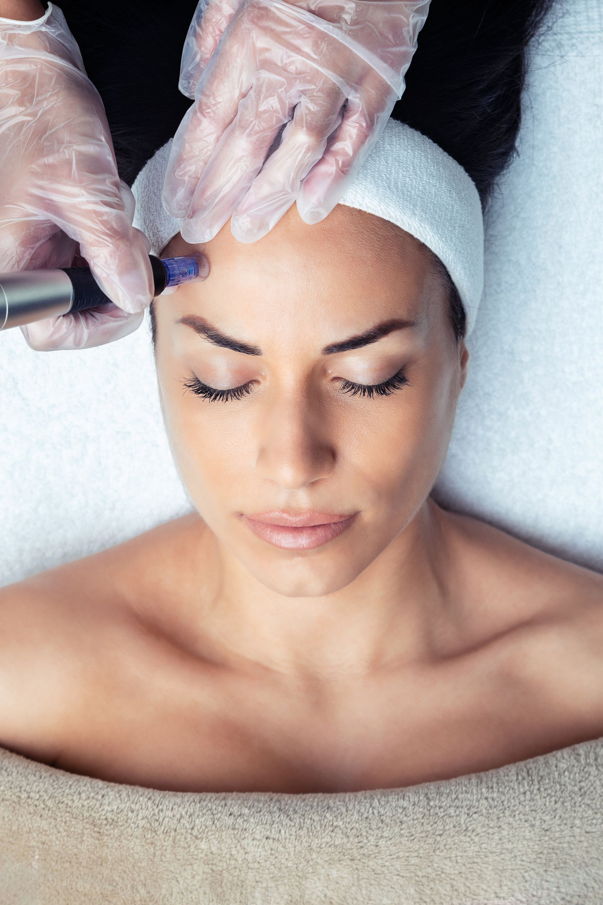 A woman is getting a facial treatment at a spa.