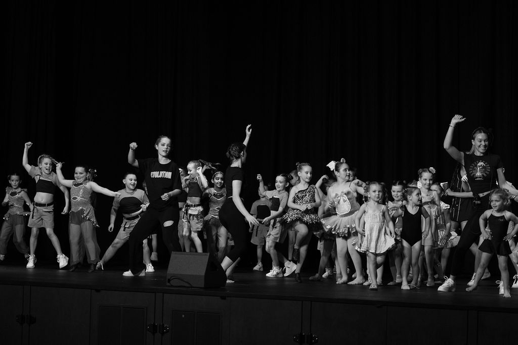 Two Young Dancers, Boy and Girl, Sitting on Stage — Mc Dynamic Studio in Currajong, QLD