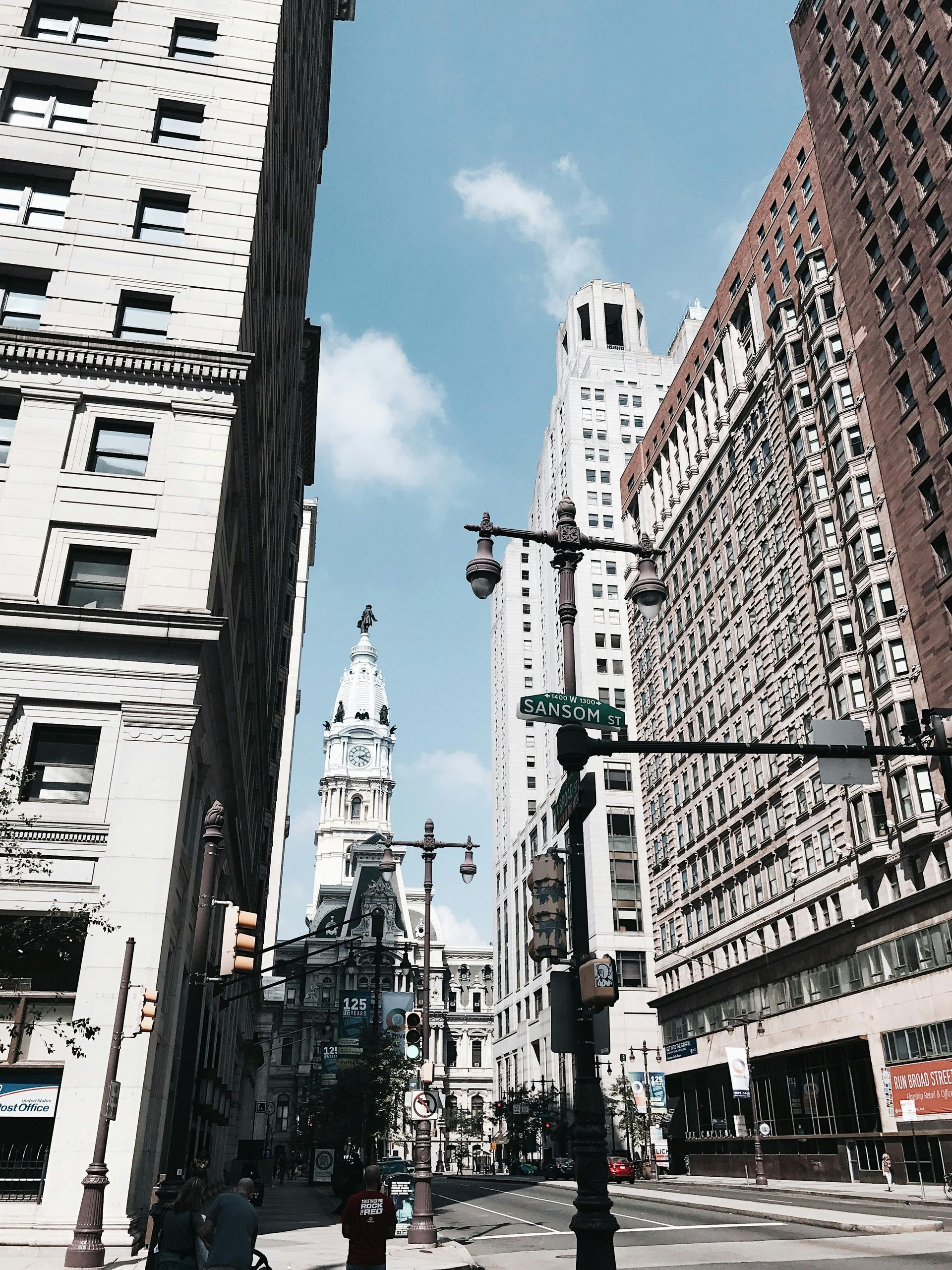 A city street with a clock tower in the background