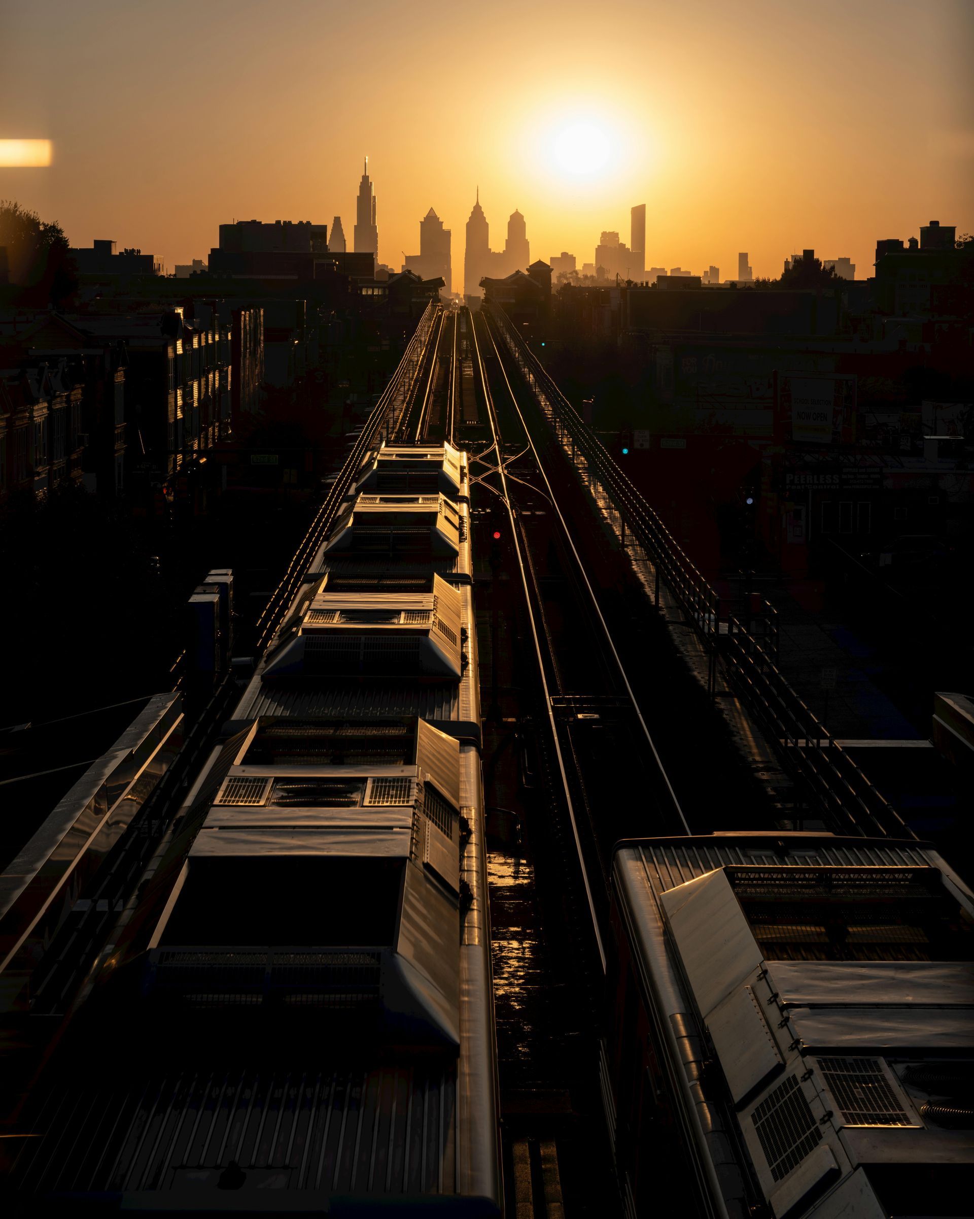 A train is going down the tracks at sunset