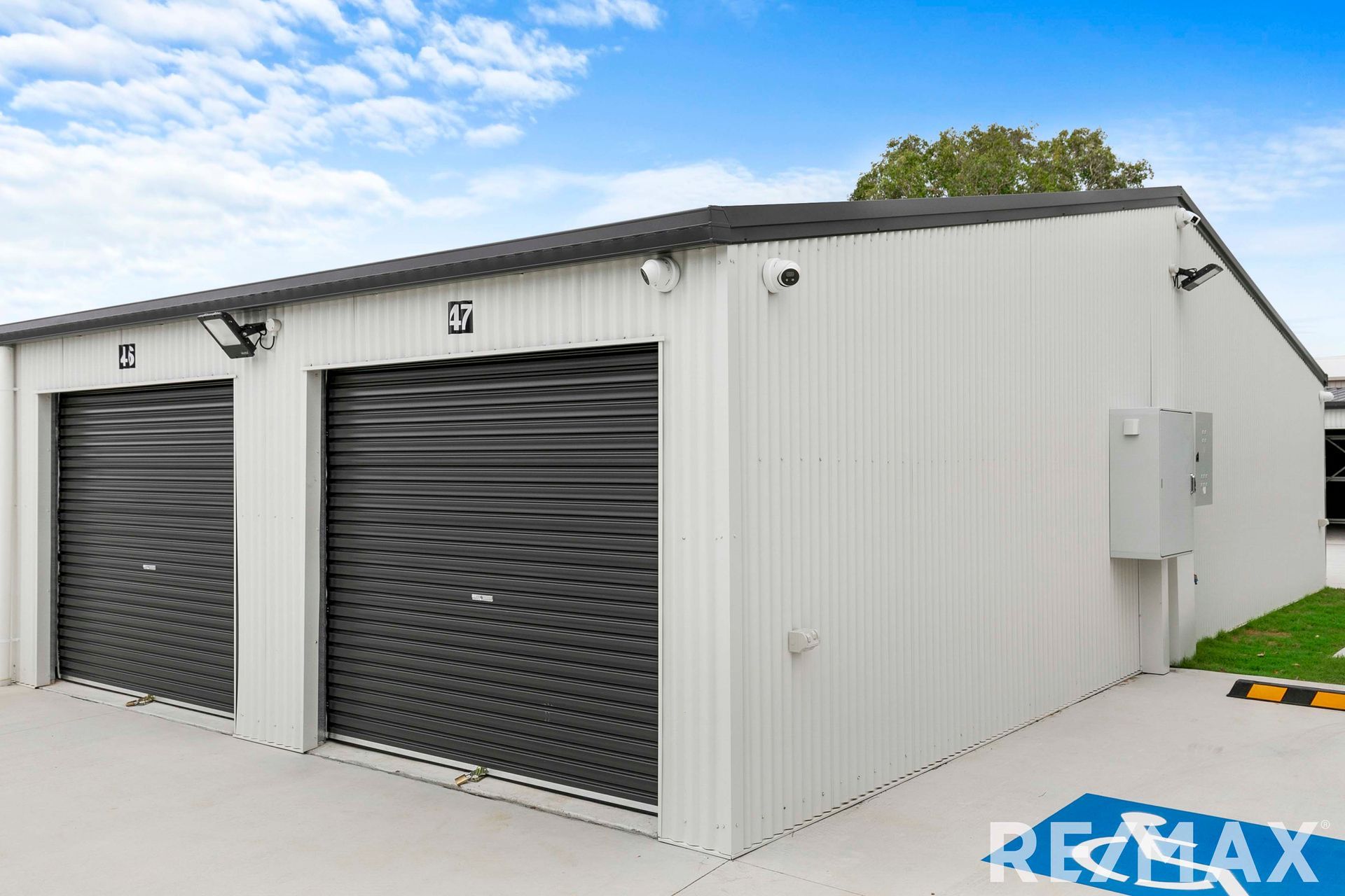 A Garage Featuring a Large Door and a Sloped Roof, Set Against a Clear Sky
